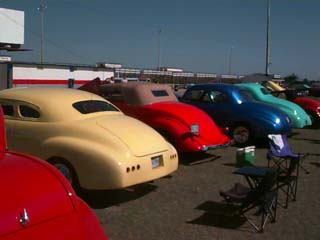 <row of street rods and hotrods>