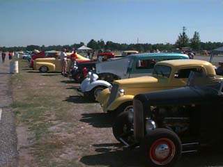 <row of hotrods and street rods>